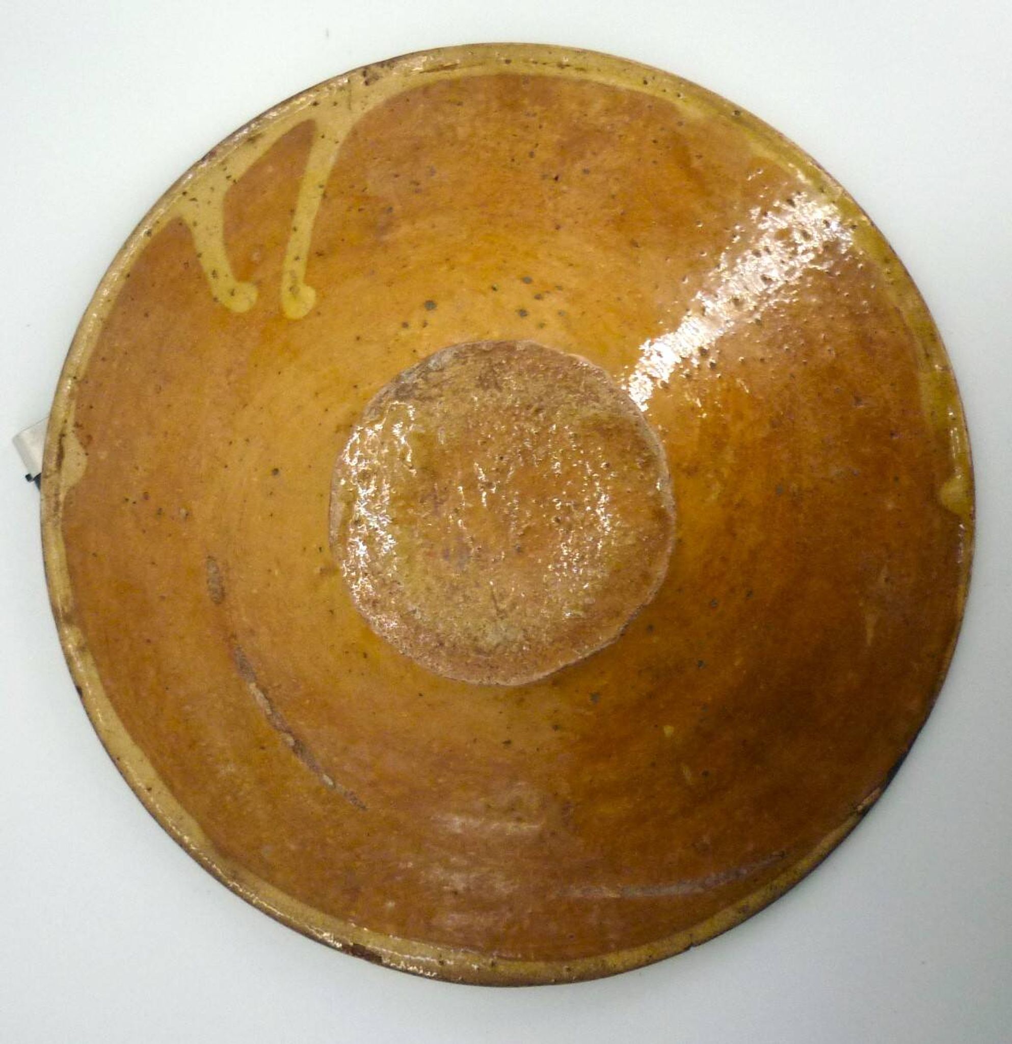 Old omelette turner, glazed yellow terracotta, south of France.