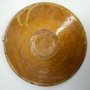 Old omelette turner, glazed yellow terracotta, south of France.