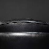 Vintage black leather swivel chair in mid-century modern Scandinavian style.