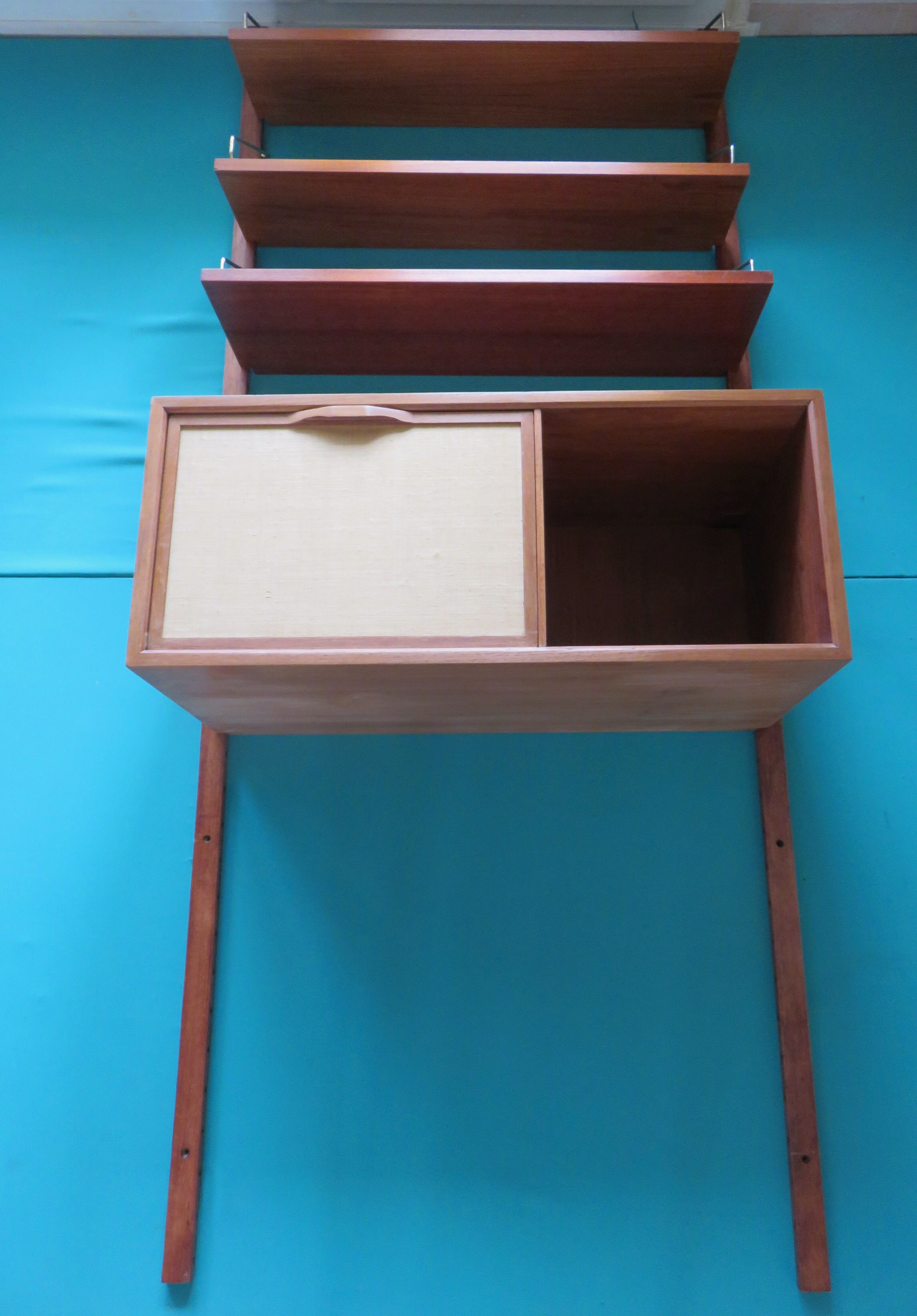 Wall shelving system and teak writing box. of Poul Cadovius. Denmark 1960