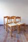 4 solid pine chairs, straw seats, shaped backrest.