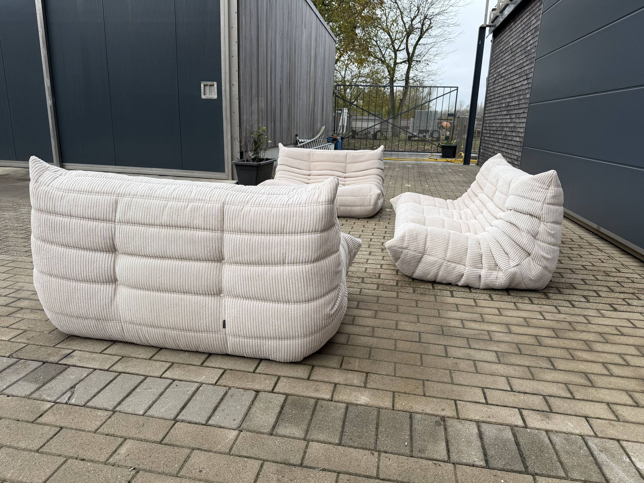 Ligne Roset Togo 3-seater and 2 x 2-seaters in beige corduroy.