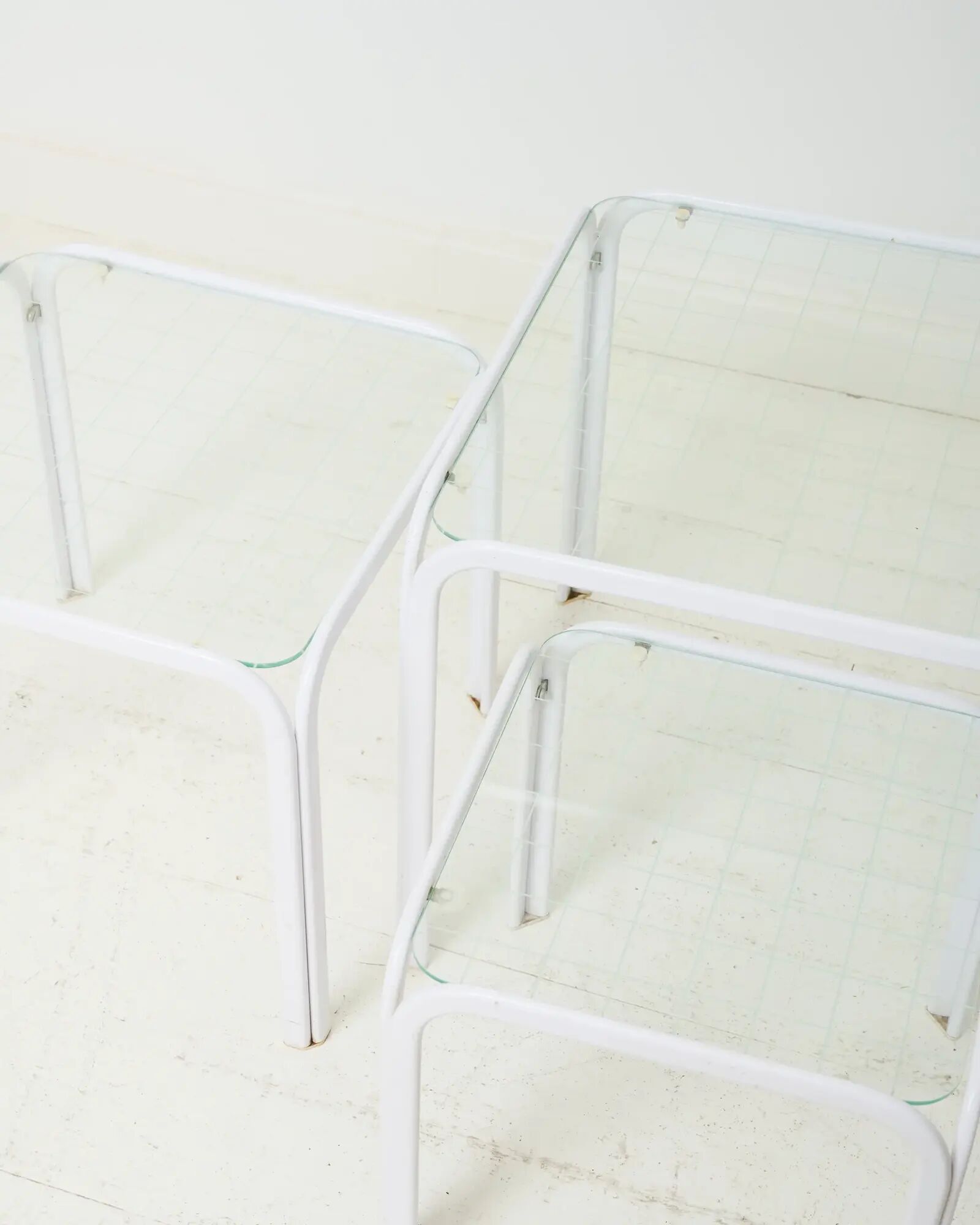 Nested tables in white lacquered metal, Italy, 1970s.