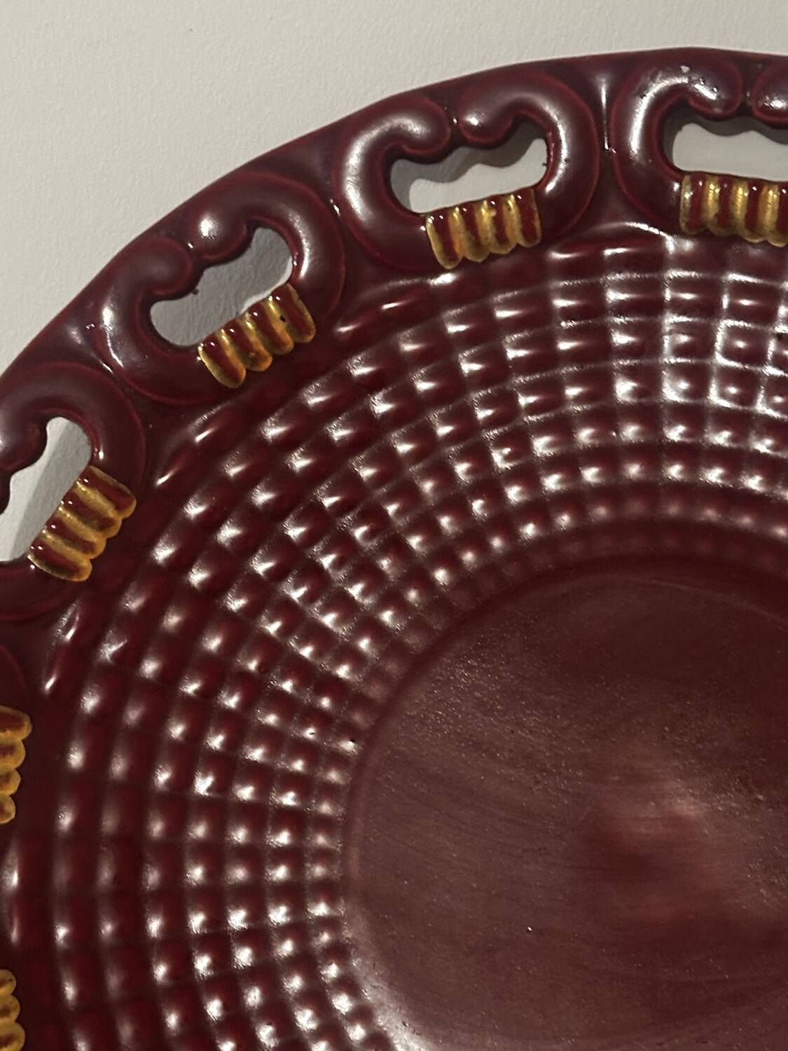 Burgundy and gold openwork plate in ceramic from Saint-Clement, 1950s.