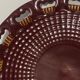 Burgundy and gold openwork plate in ceramic from Saint-Clement, 1950s.