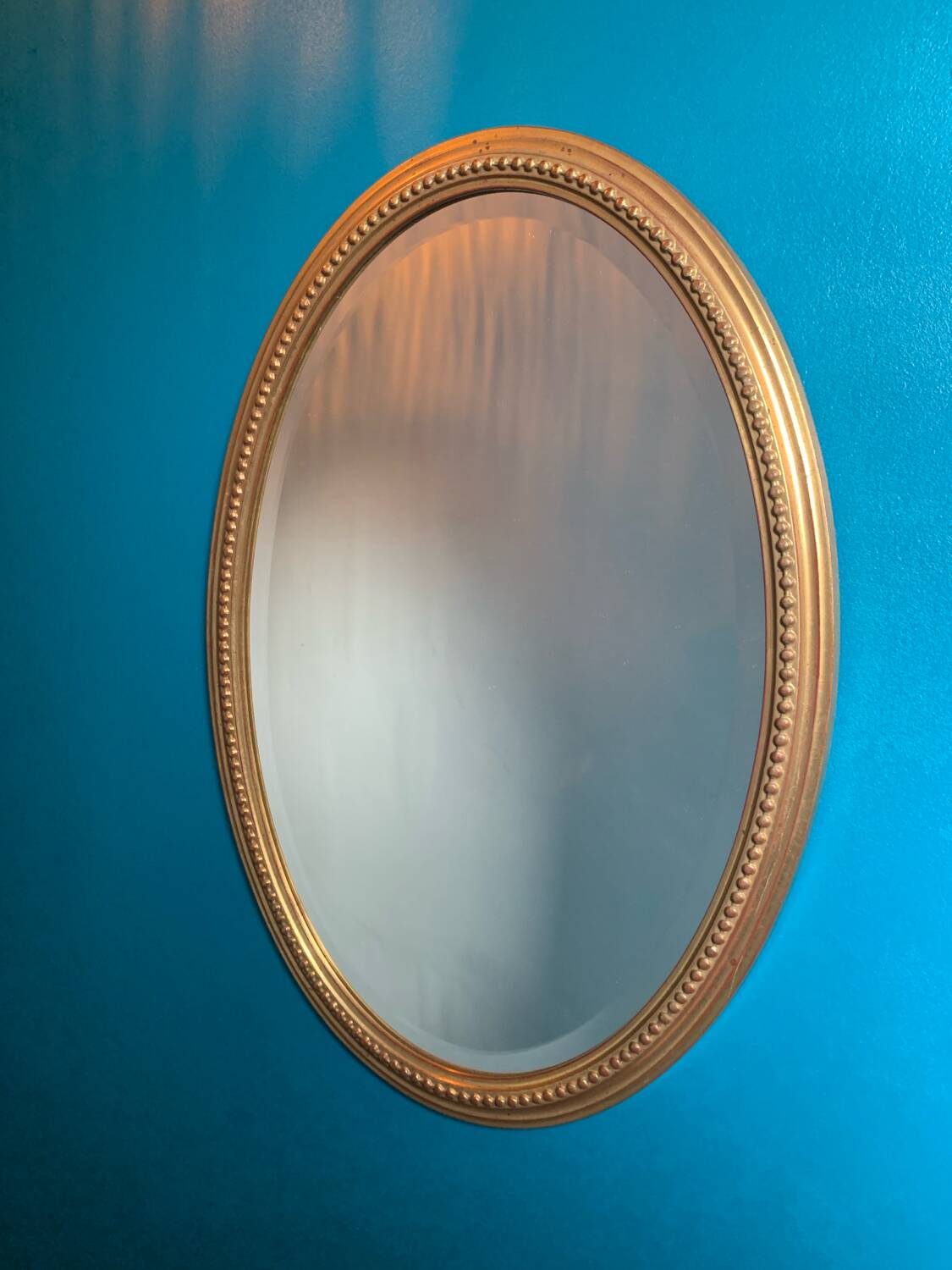 Vintage beveled gold oval mirror