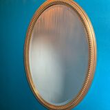 Vintage beveled gold oval mirror