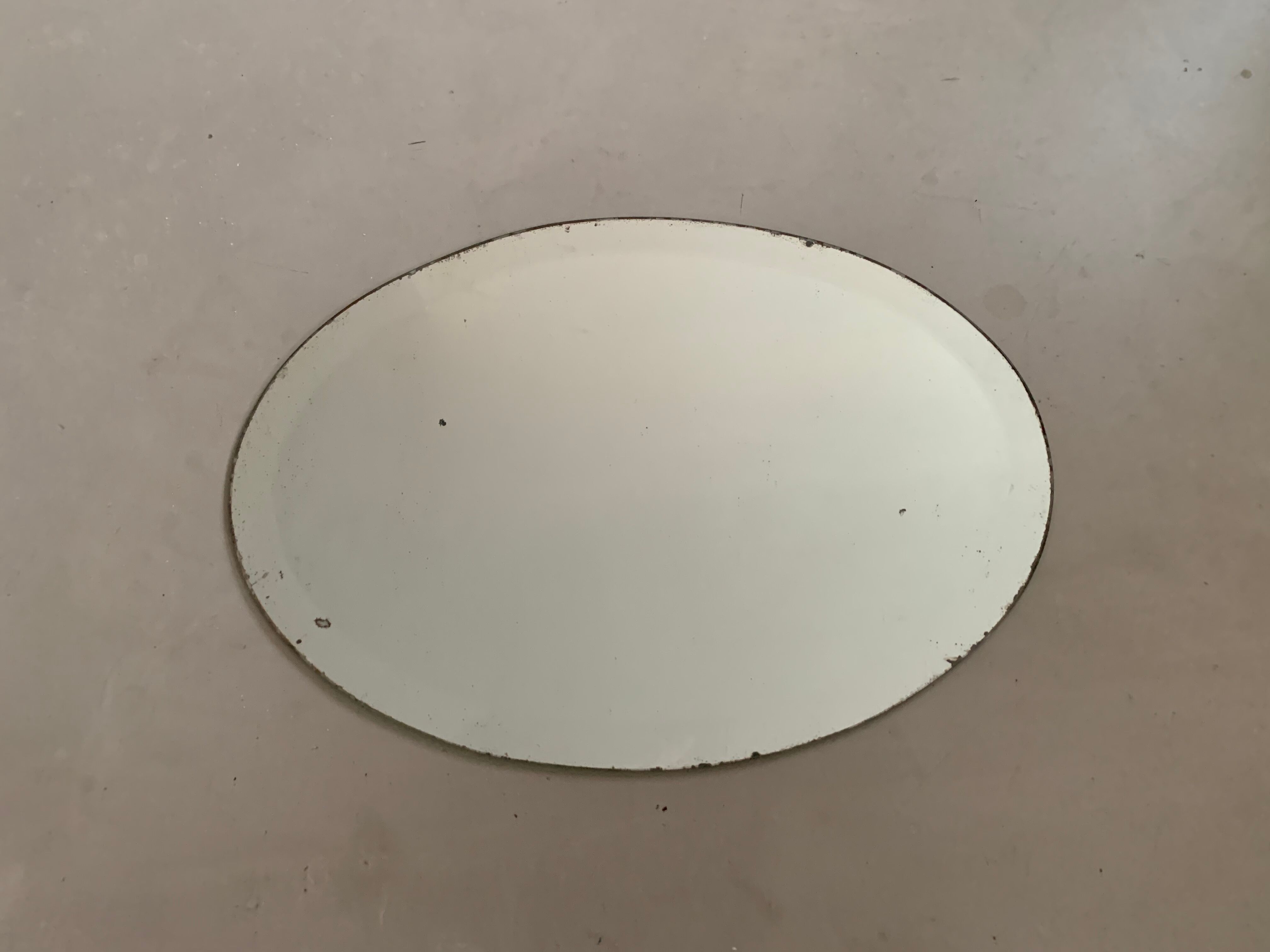 Old bevelled stitched oval mirror