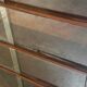 Vintage 1960s wooden library with sliding doors.