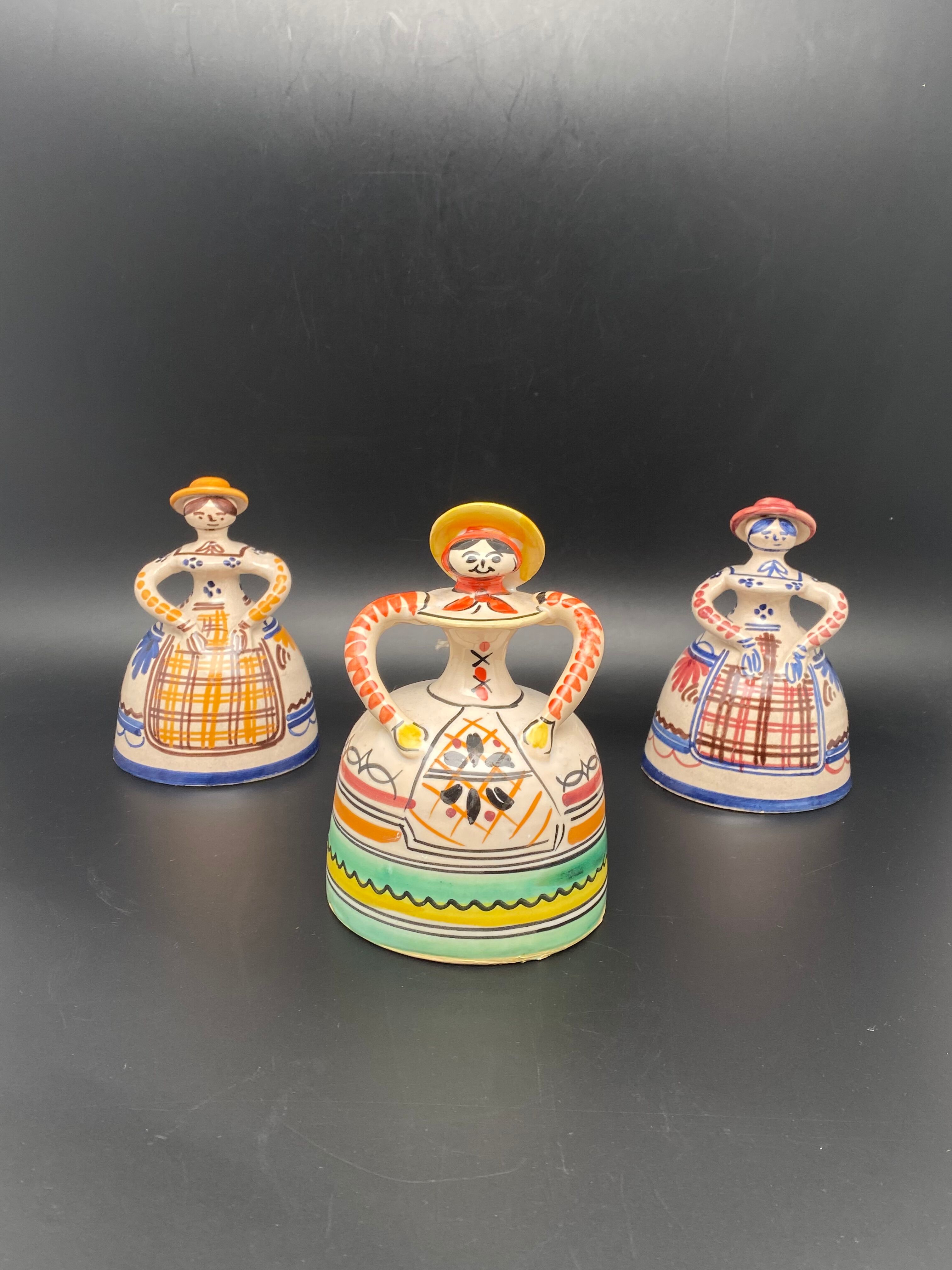 Trio of ceramic bell figurines