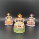 Trio of ceramic bell figurines