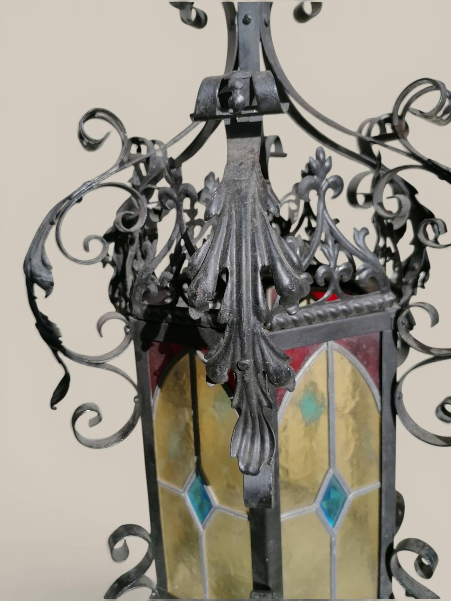 Black wrought iron lantern with stained glass. Medieval, Gothic decoration.