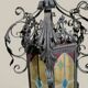 Black wrought iron lantern with stained glass. Medieval, Gothic decoration.