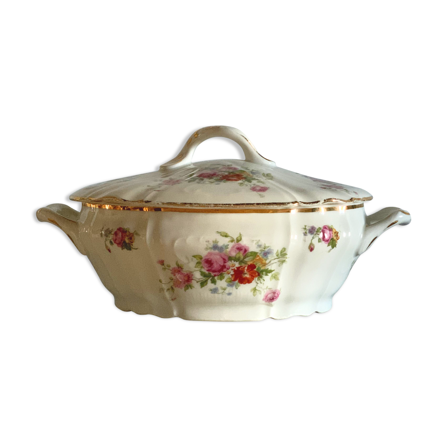 Antique porcelain soup bowl with floral decoration and golden border