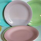 Seven pastel-colored plates mixed with vintage earthenware