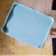 Small vintage bedside table with patinated azure blue wood.