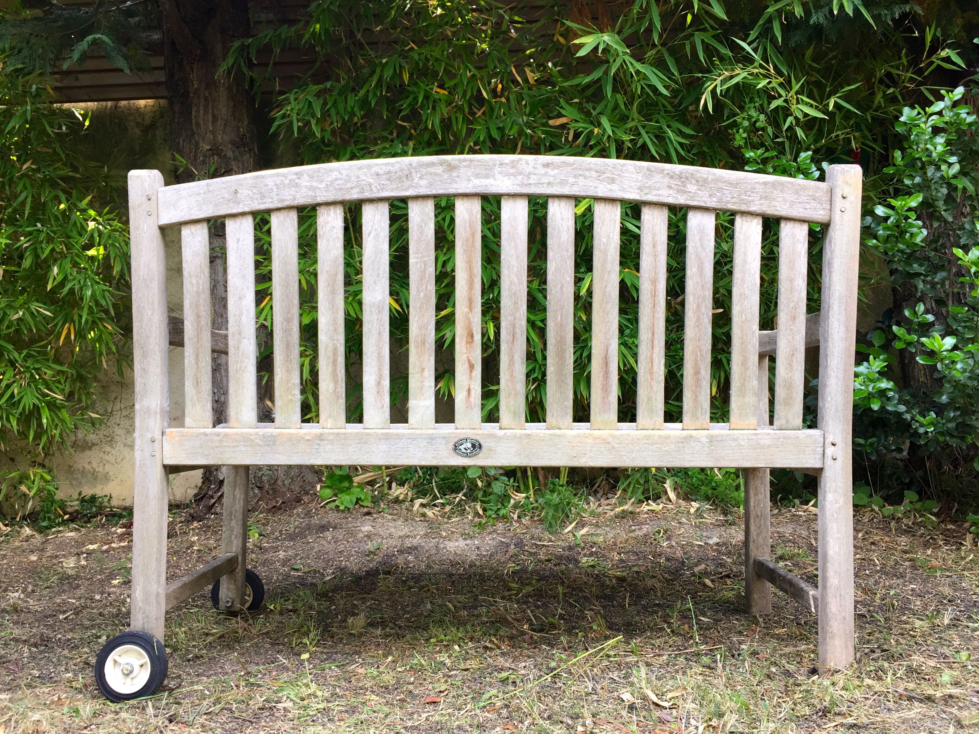 Vintage wooden garden bench with wheels