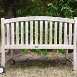 Vintage wooden garden bench with wheels
