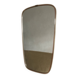 Vintage 1960s mirror in a freeform shape with a gold and red trim.