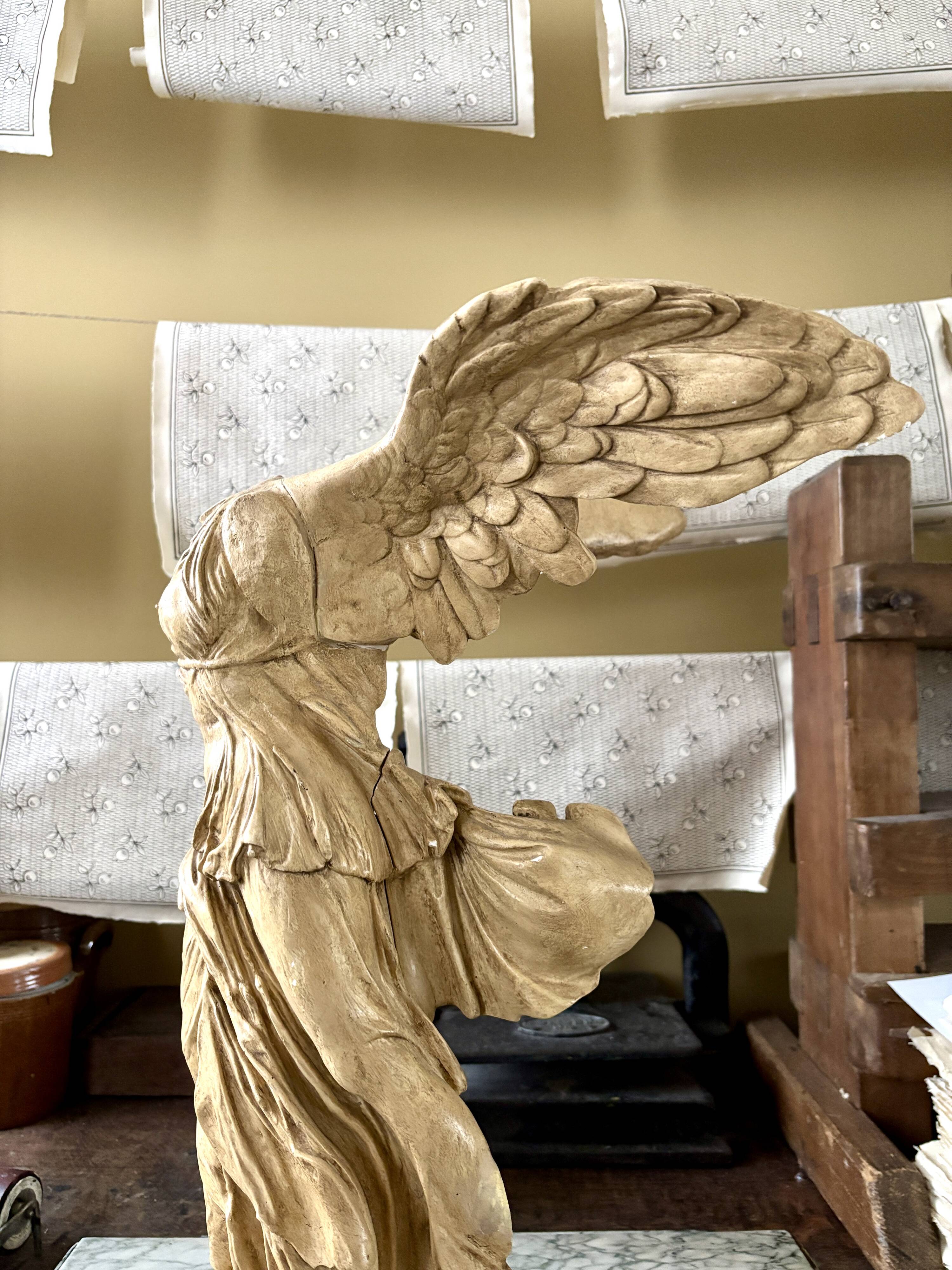"Winged Victory of Samothrace", beige plaster statuette