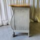 Curved patinated chest of drawers