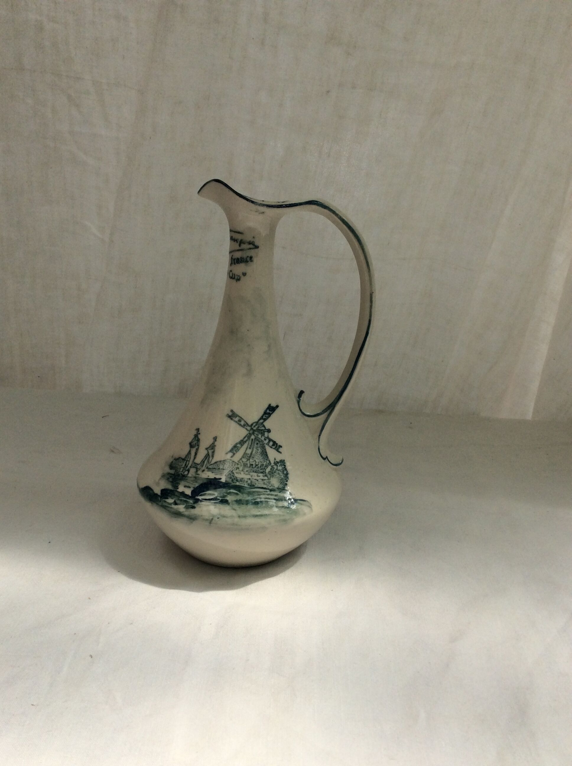 Old pitcher in Dutch-made earthenware signed
