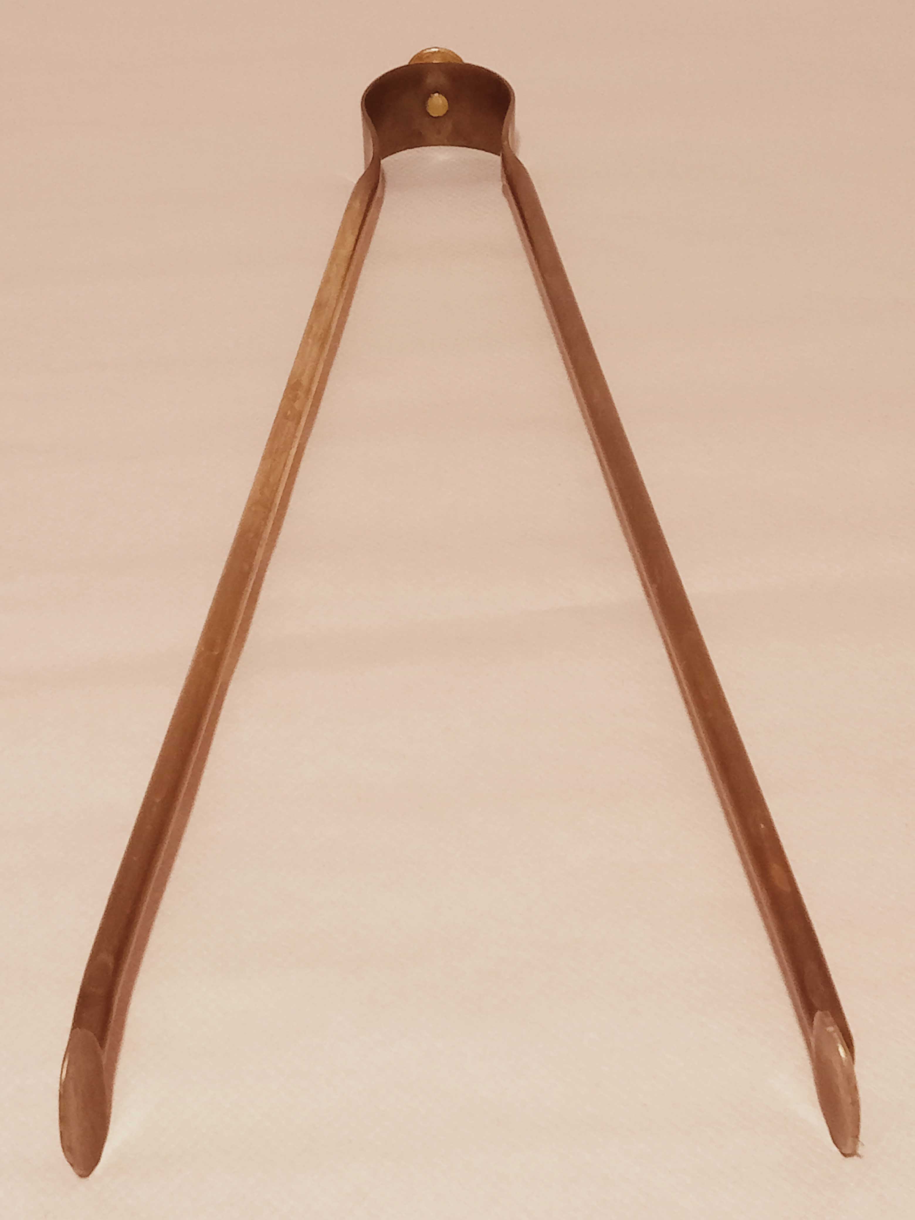 Old bronze or brass fireplace clamp