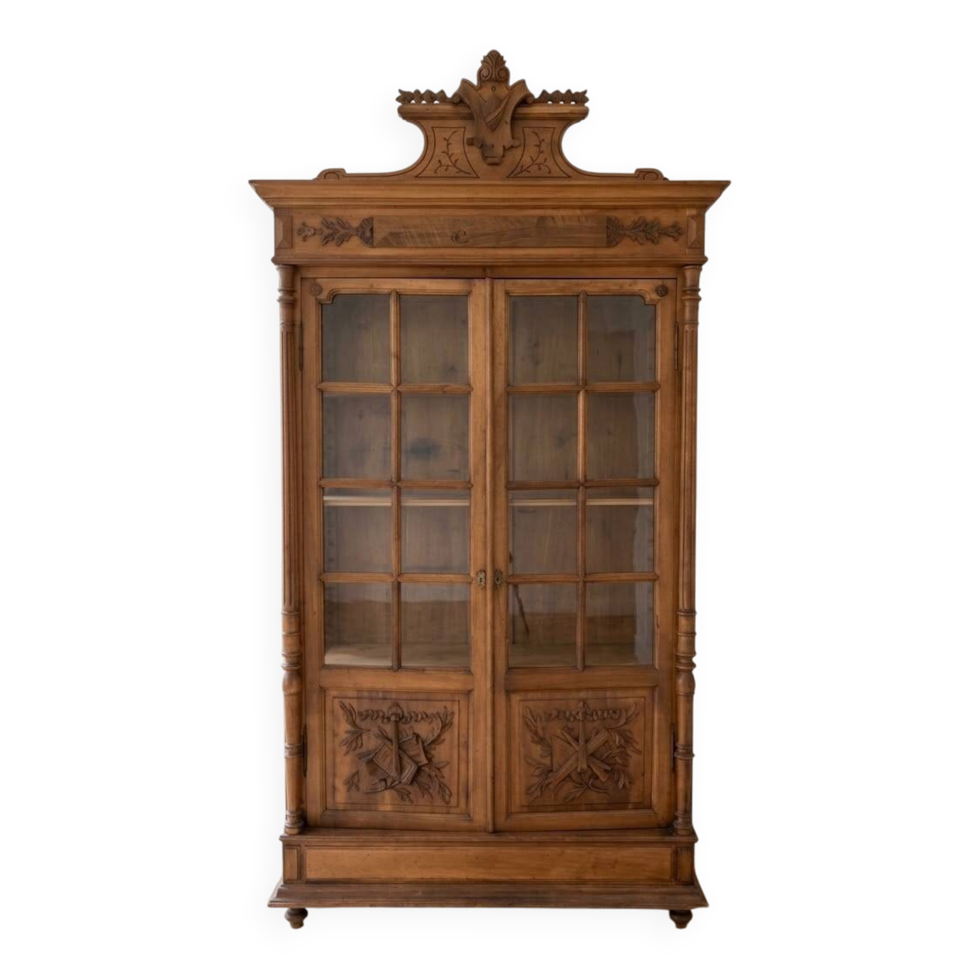 Antique wooden library with a carved pediment.