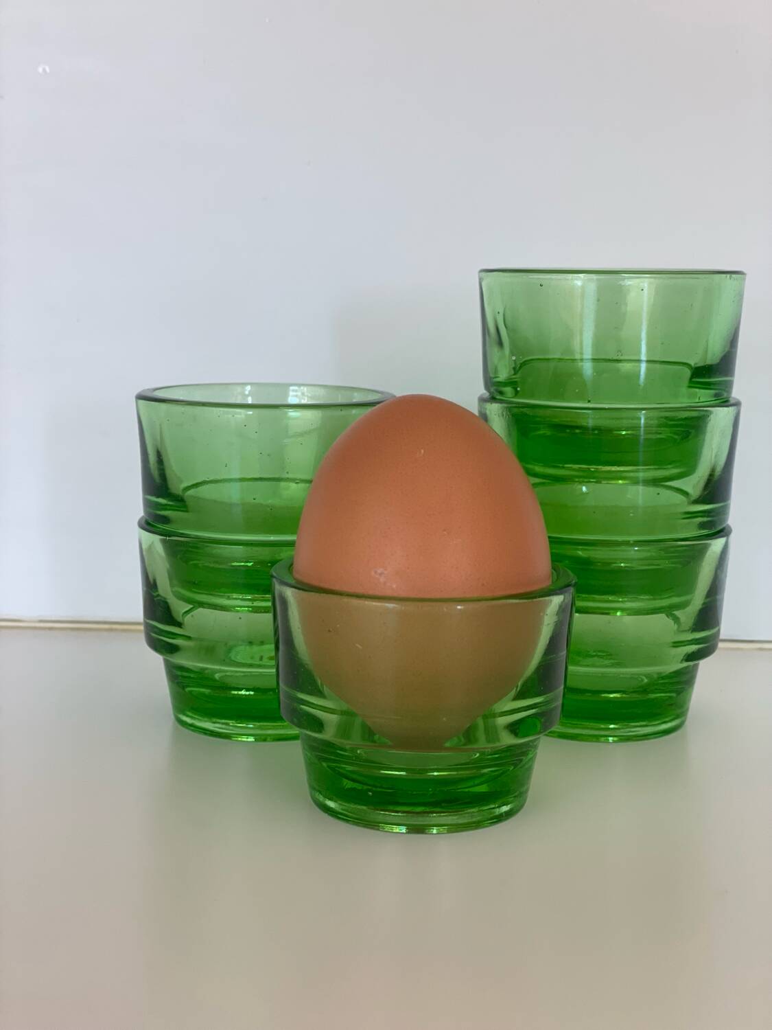 6 egg cups, green glass digestif glasses Lever.