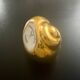 2 Snail-shaped salt pots in gold-colored porcelain