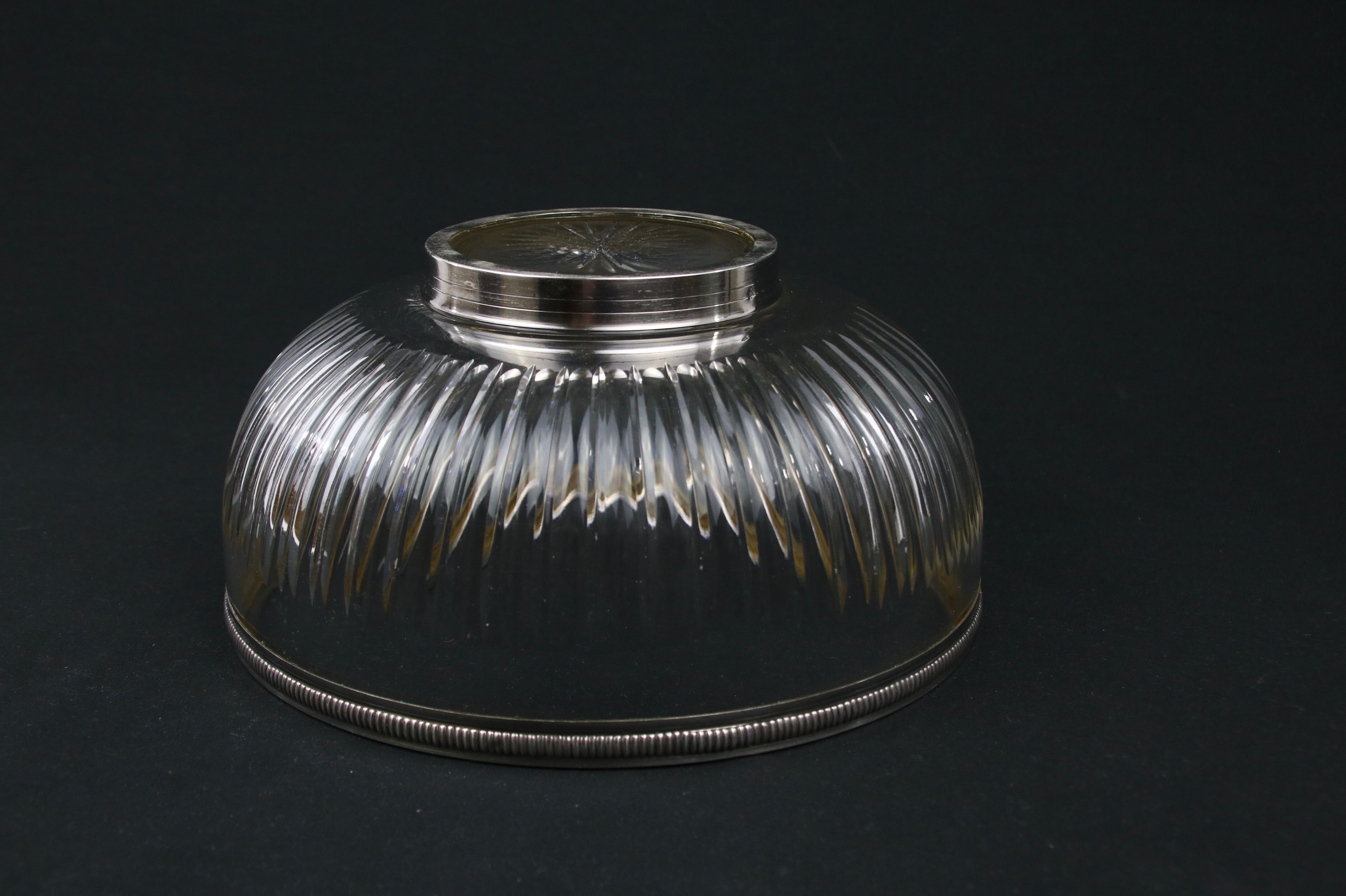 Crystal cup surrounded by two silver friezes