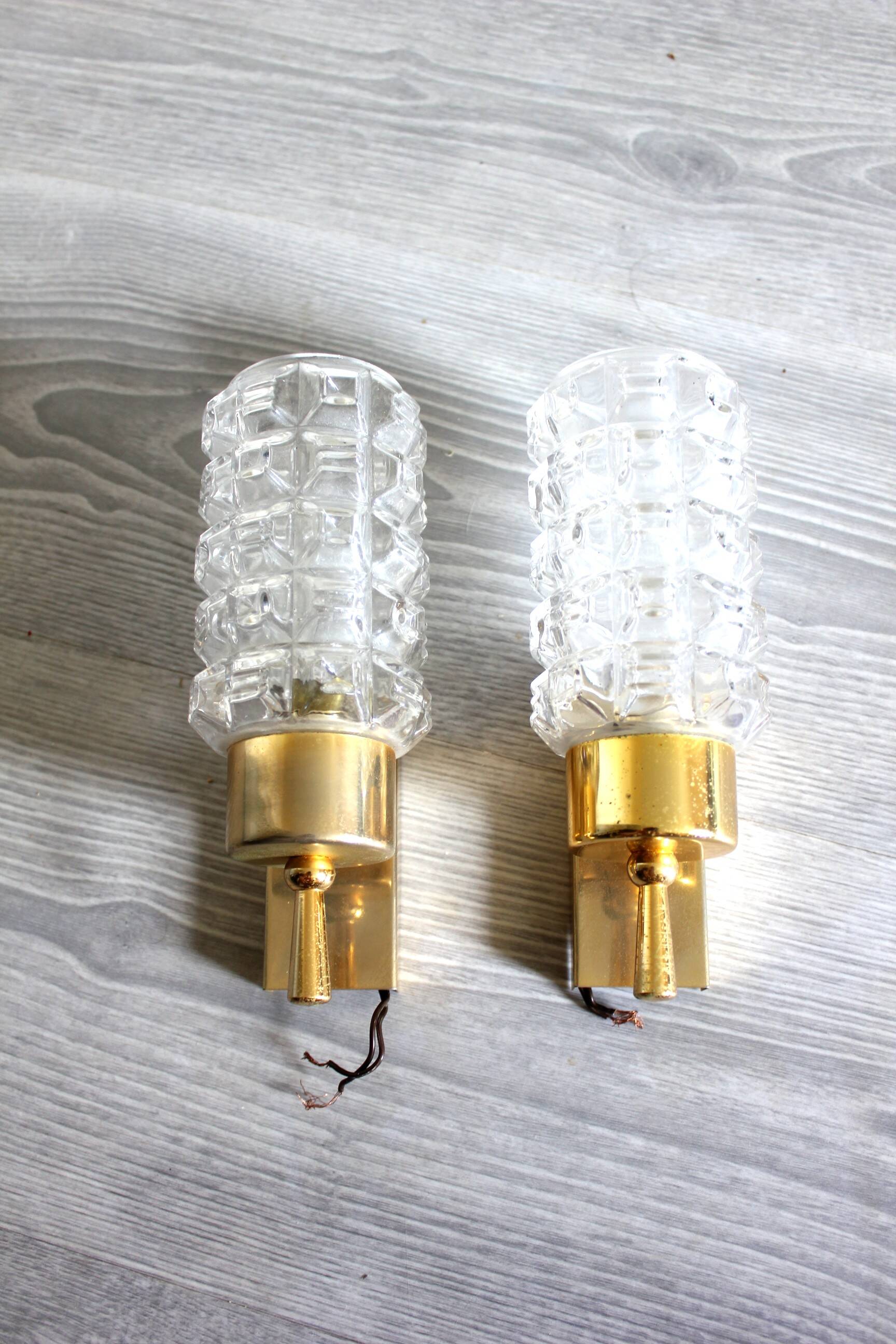 Pair of vintage wall sconces in gilded brass with moulded glass.