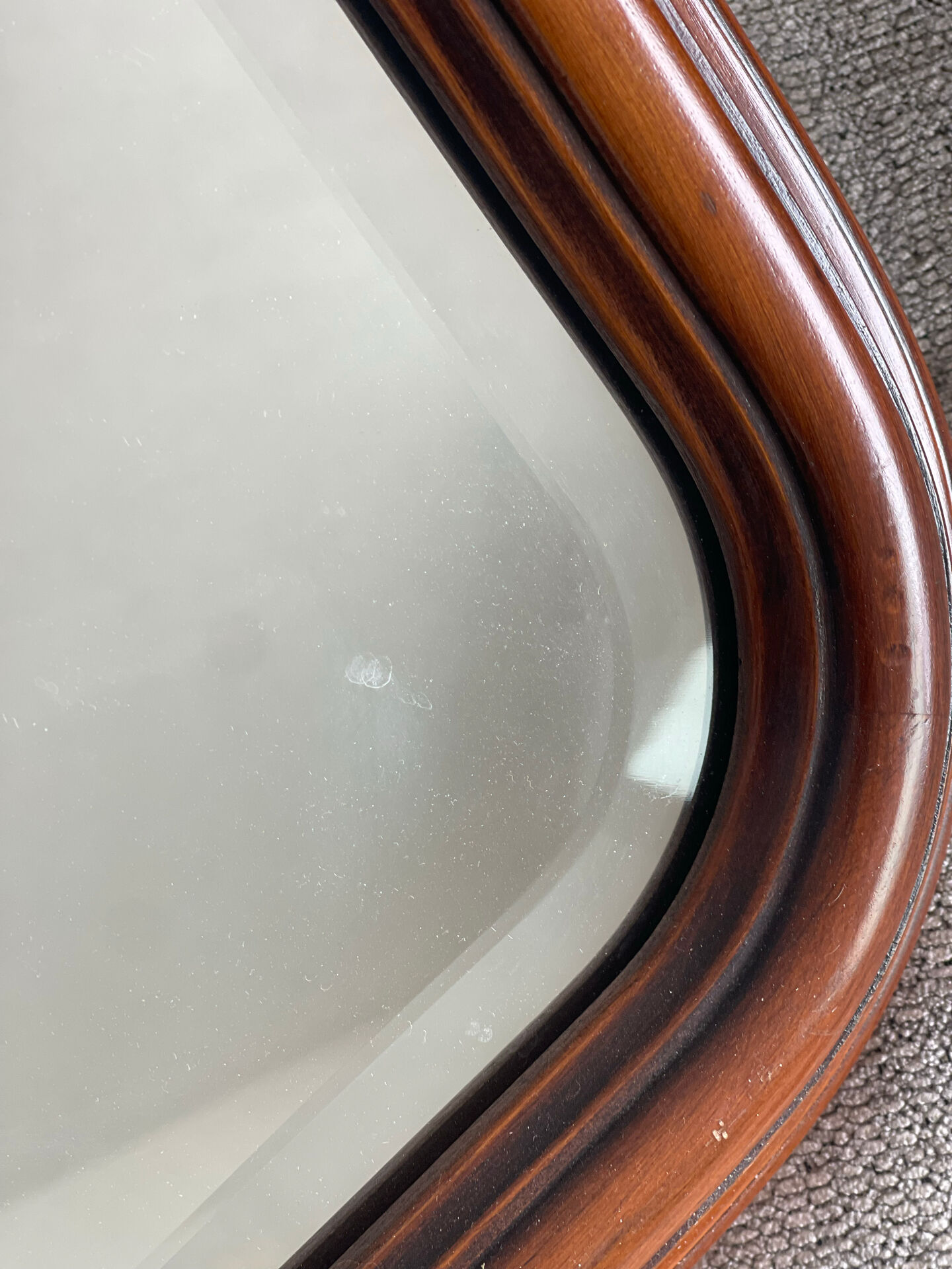 Vintage wooden framed mirror with bevelled glass.