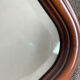 Vintage wooden framed mirror with bevelled glass.