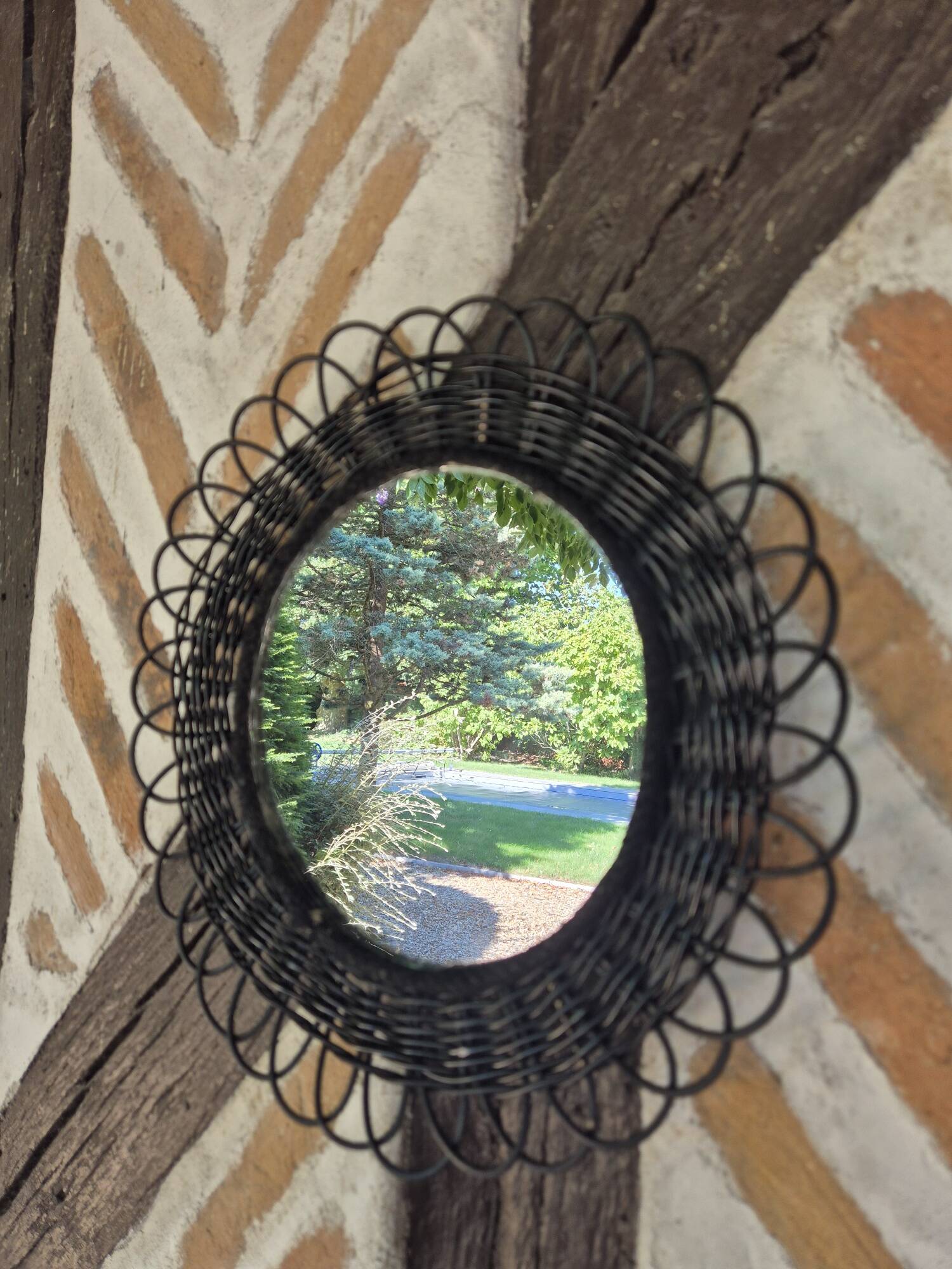 Vintage black rattan flower mirror