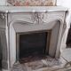Louis XV style fireplace in veined white Carrara marble and XI ceramics.