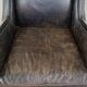 Black cow leather armchair in industrial style finished with decorative nails