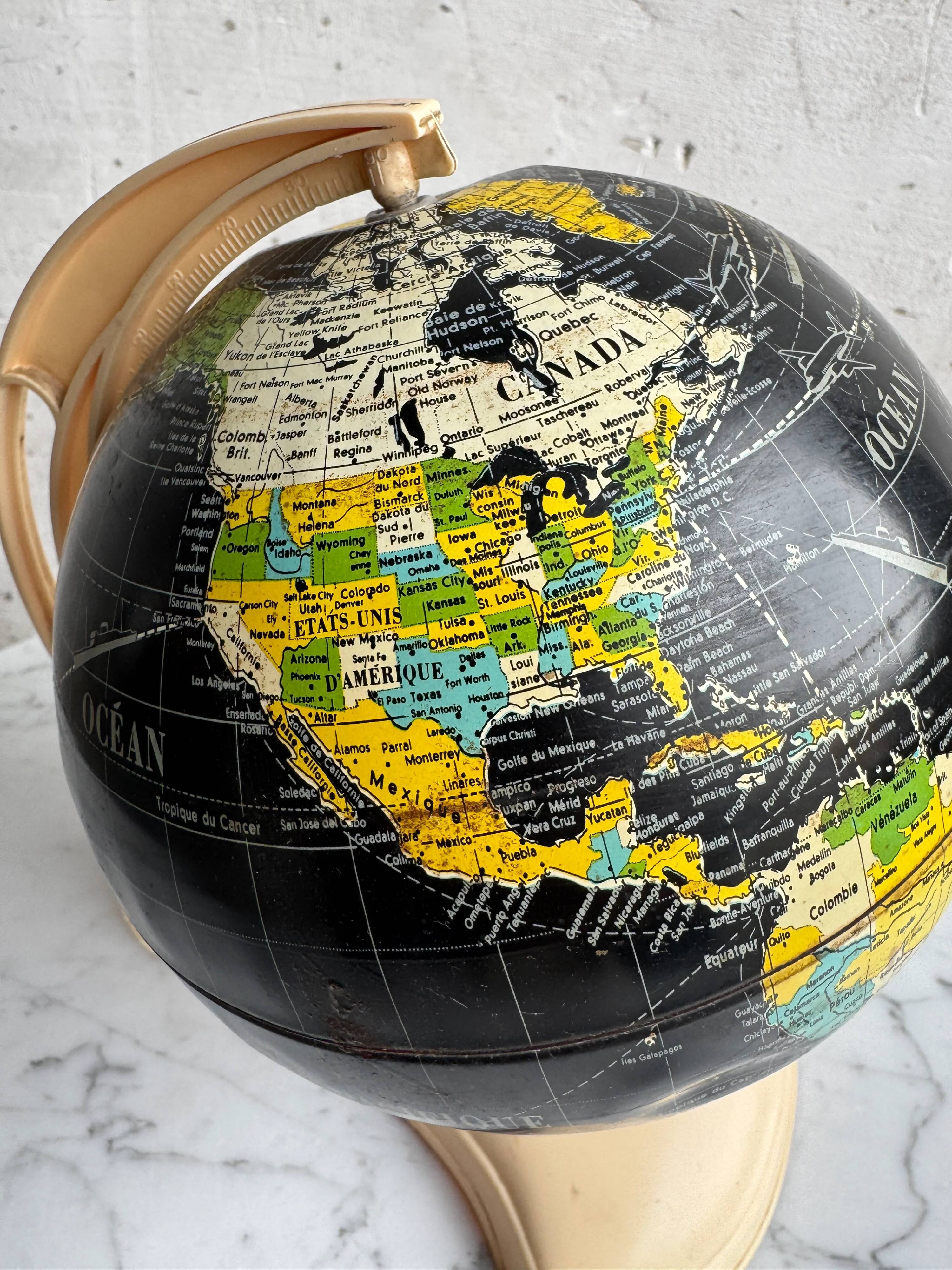French mid-century school globe with black oceans on printed paper, cream plastic base