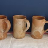 Suite of five sandstone mugs