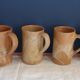 Suite of five sandstone mugs