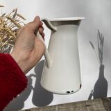 Old white enamelled metal pitcher