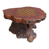 Brutalist chessboard coffee table made from tree stump.
