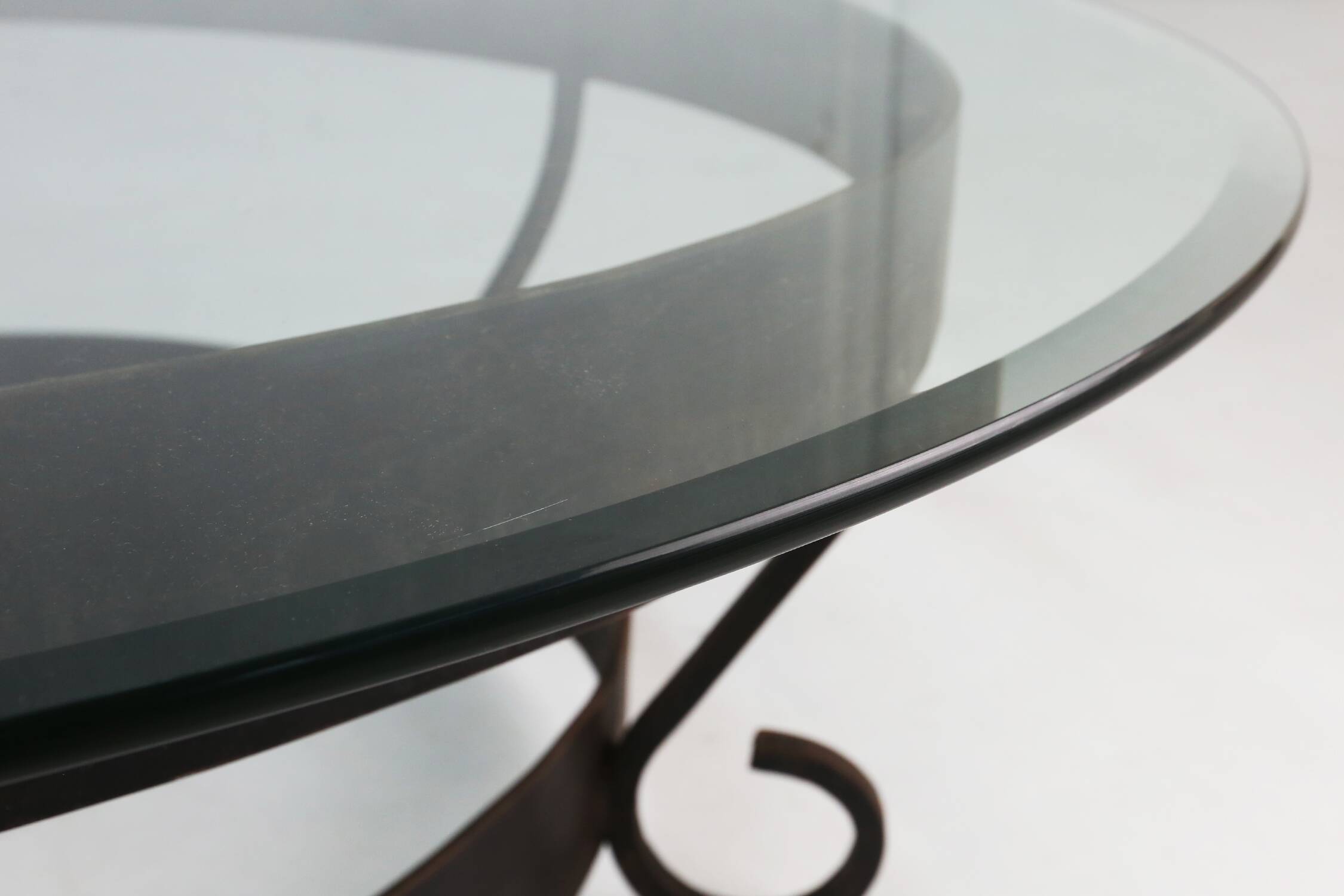 Rustic round coffee table with wrought iron base and glass top, France, 1930s