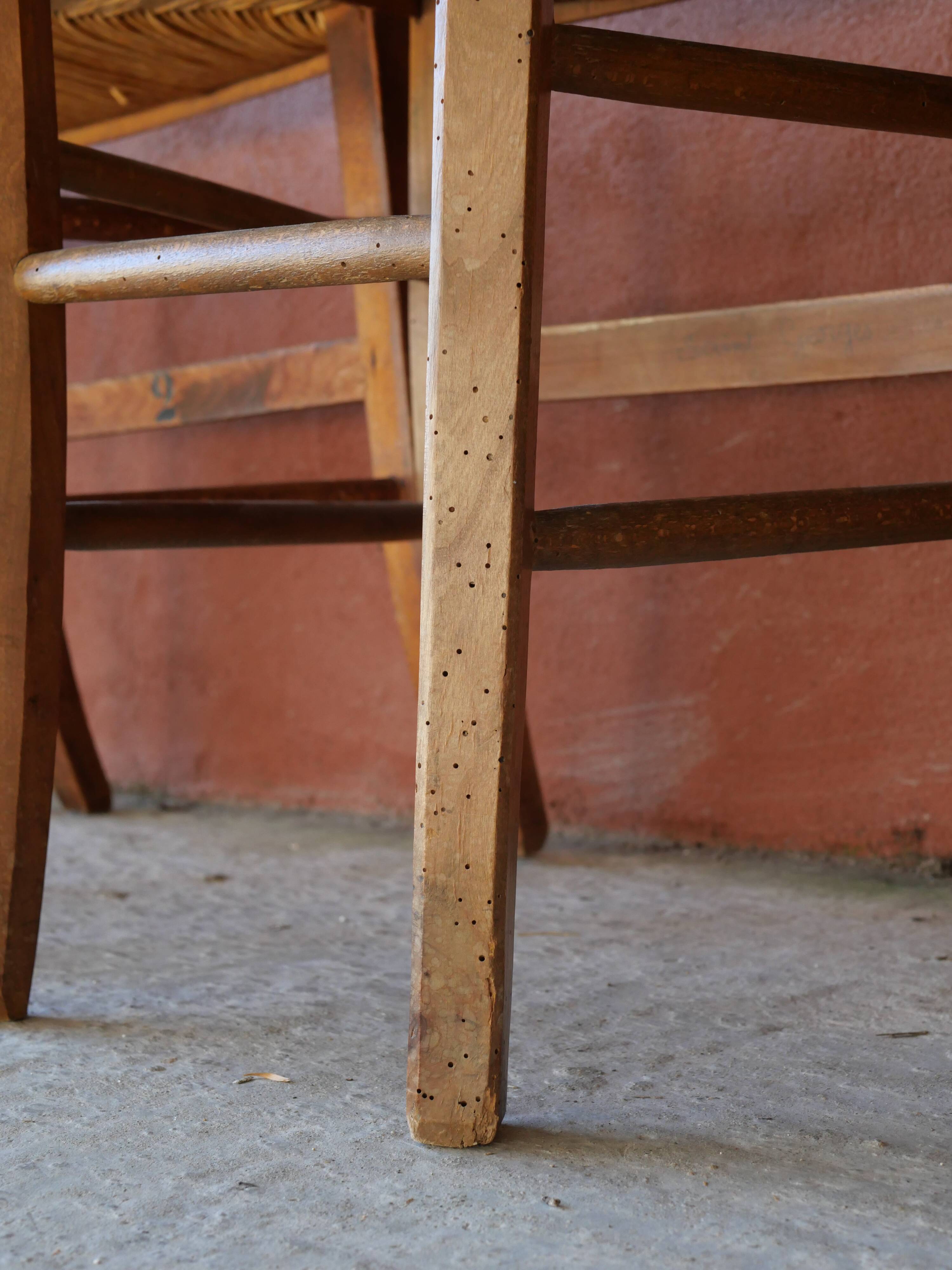 Set of 5 mismatched straw chairs.