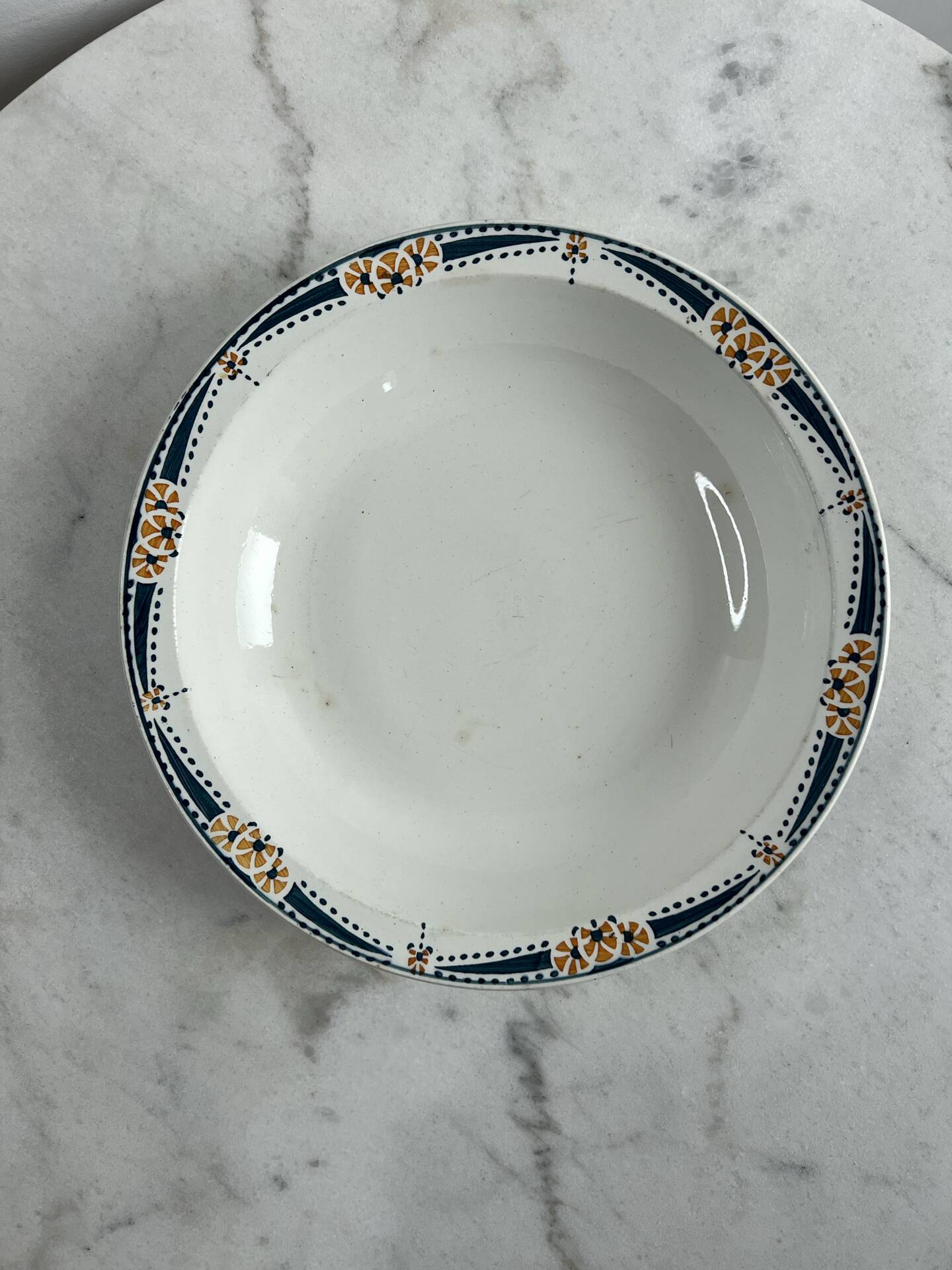 Longwy salad bowl with blue and orange floral decoration.