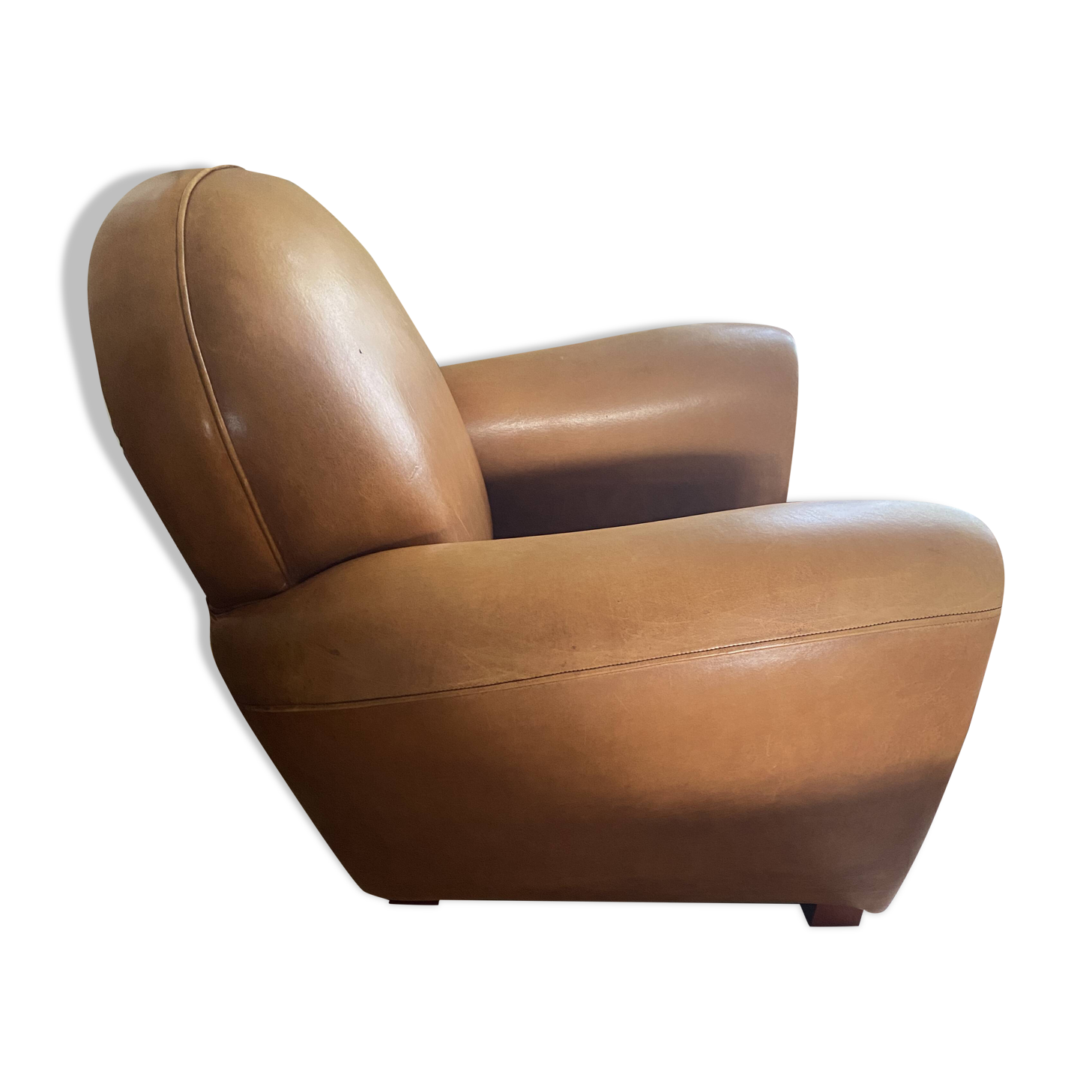 Brown leather club armchairs with an antique finish.