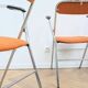 6 orange folding chairs