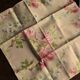 A set of 6 mismatched floral and bird-themed napkins