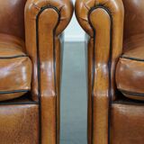 Ensemble de 2 fauteuils en cuir de mouton avec finition passepoil noir