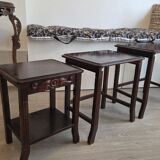 Nested tables made of varnished solid wood.